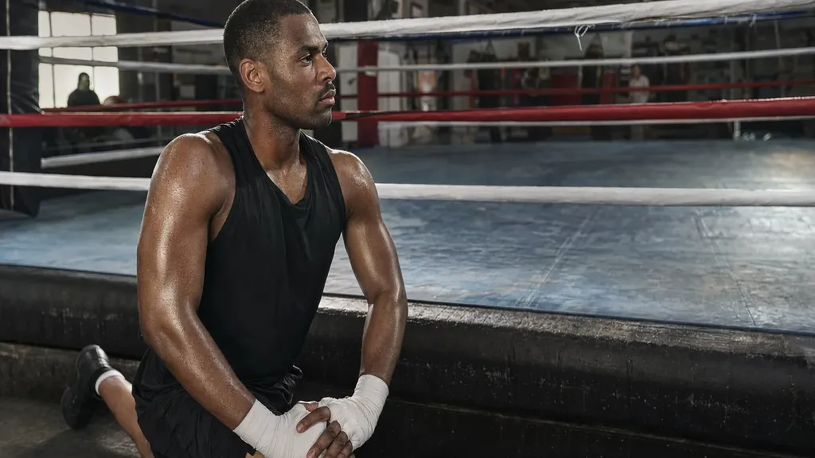 Boxer stretching beside a boxing ring before training in a London gym