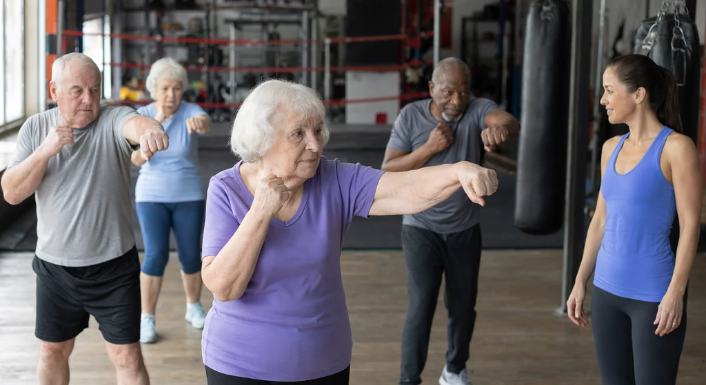 Mixed-age recreational boxing class working in a gym