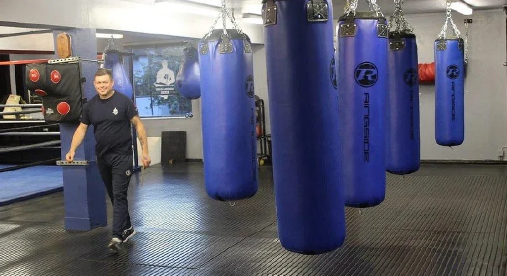 Heavy bags and gym floor space set up for adult boxing fitness at Honour and Glory