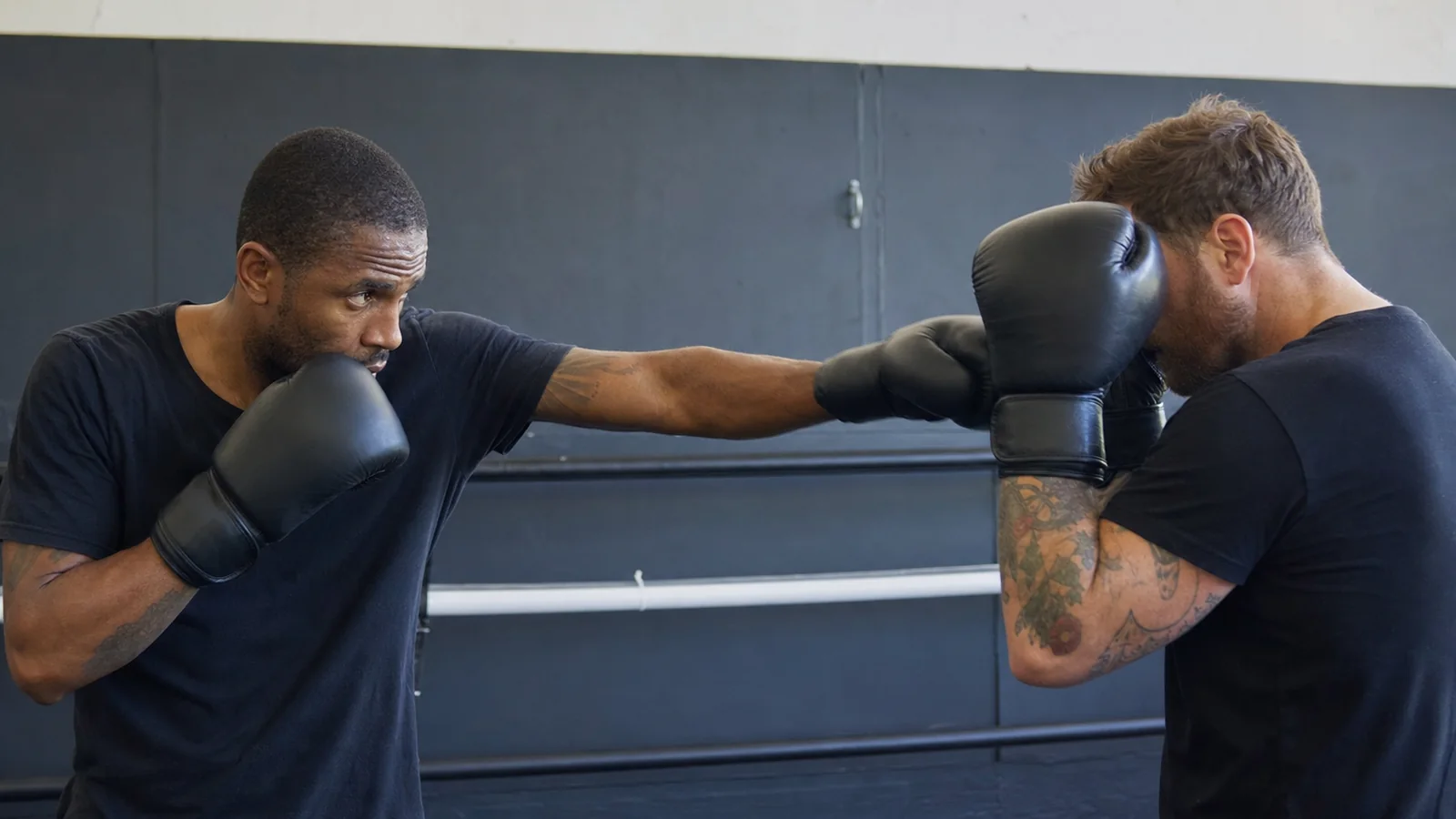 Amateur boxer building the round behind a disciplined jab as the default action