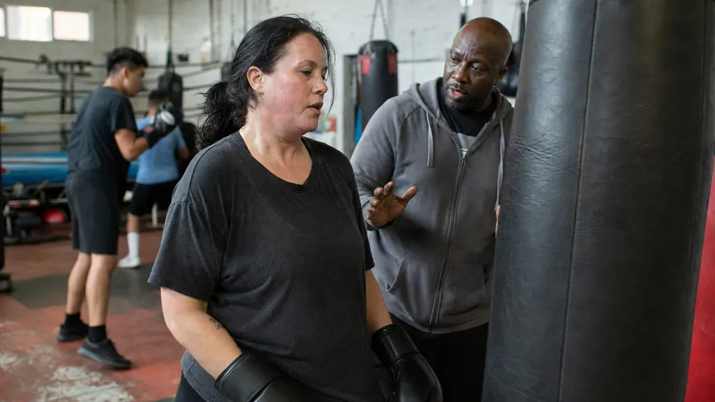 Adult beginner finishing focused bag rounds as part of a realistic boxing fitness plan