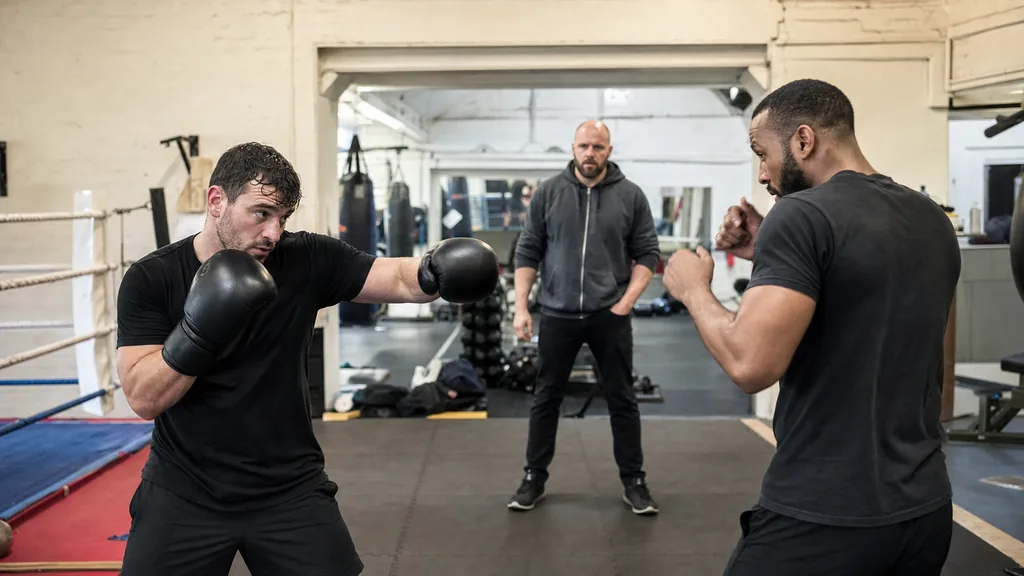 Adult boxer holding a guarded position during a controlled technical distance drill