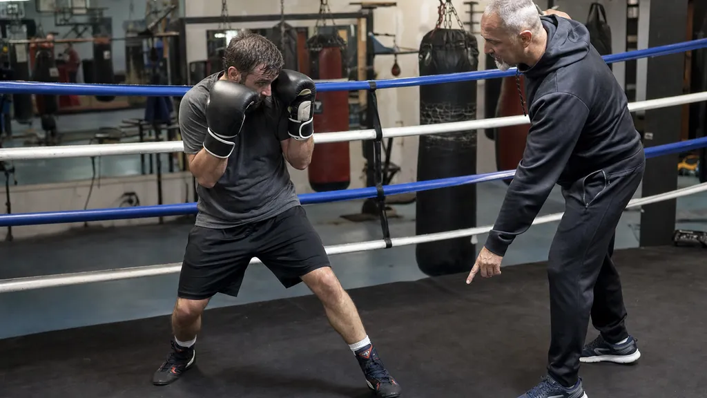Boxer using a compact catch against a jab while keeping the rear hand close to the cheek