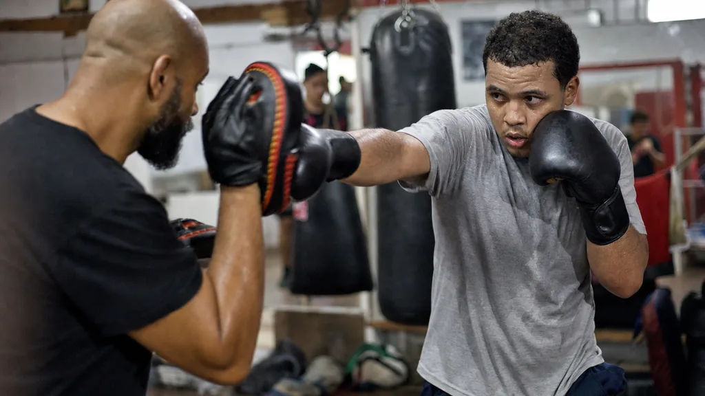 Adult boxer practising a right hand while the lead glove stays tight to the cheek