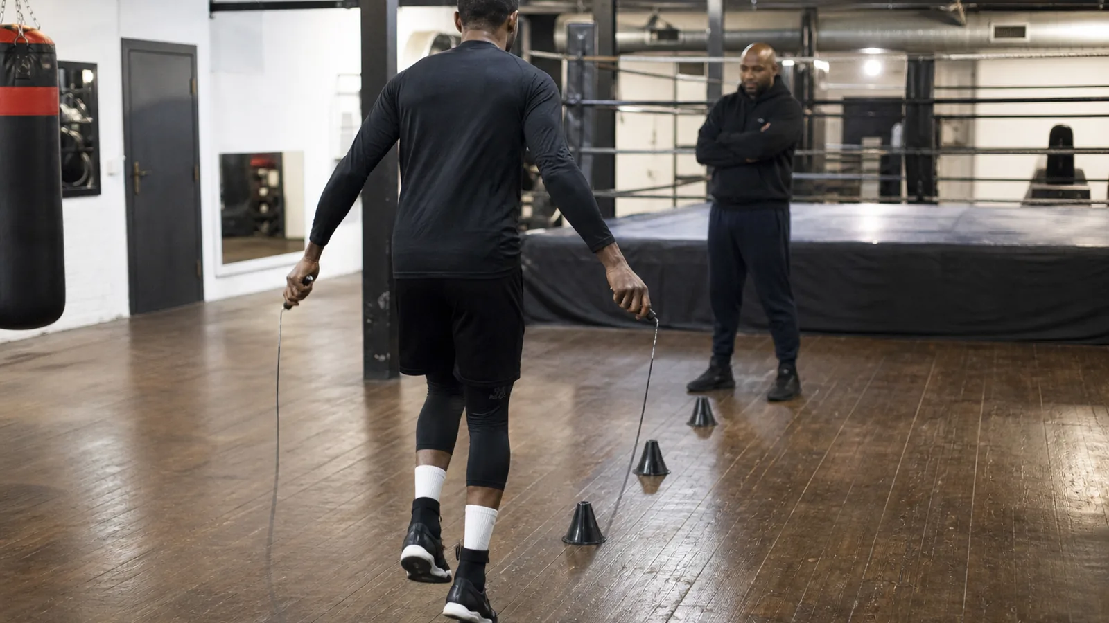 Anonymous boxer drilling footwork patterns during gym preparation