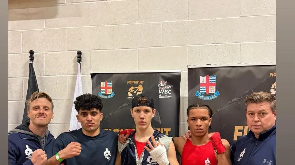 Amateur boxers gathered ringside during a competition day