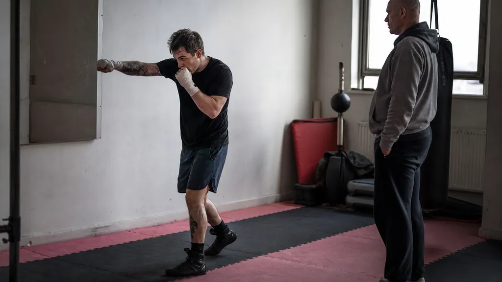 Adult recreational boxer shadow boxing slowly while practising hands returning to guard