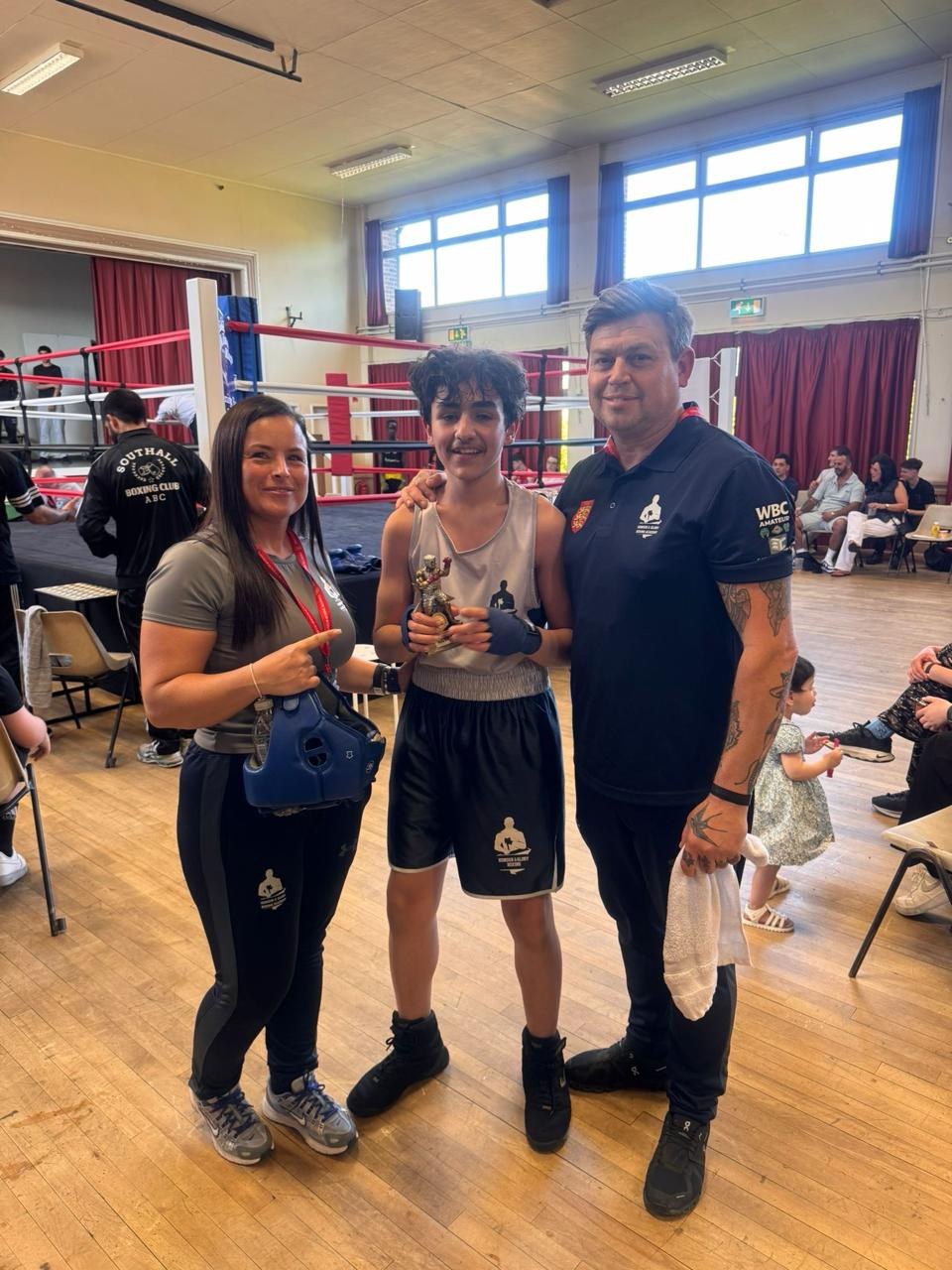 Memet with his trophy after a junior competitive boxing win