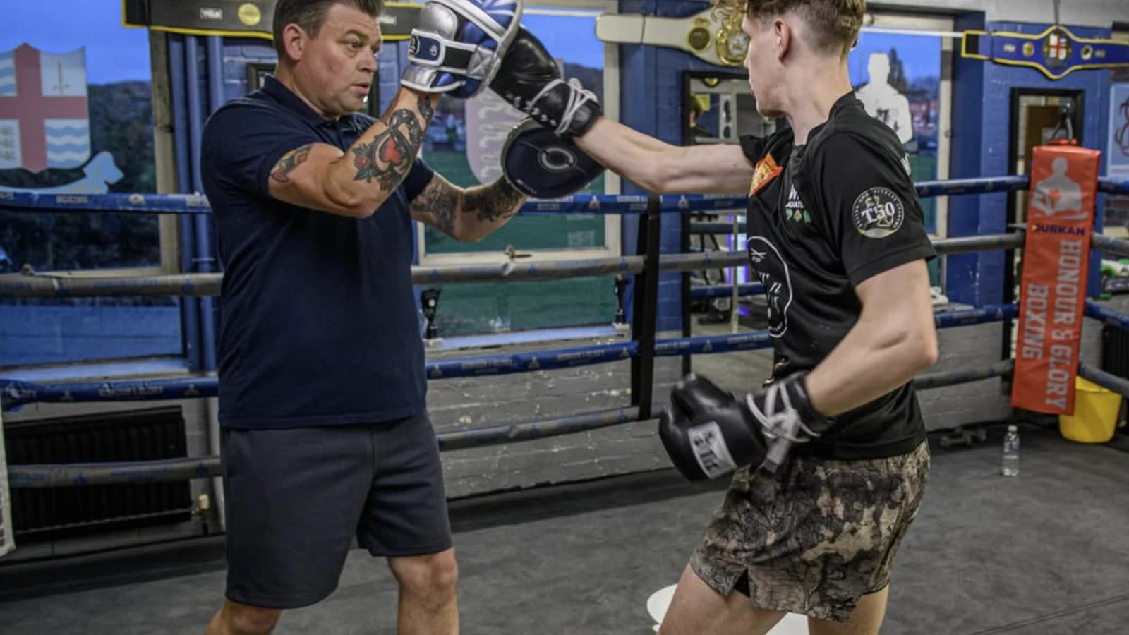 Anton coaching padwork with an adult boxer in the Honour and Glory ring
