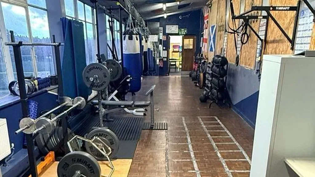 Boxing gym interior with heavy bags and ring - fitness boxing classes