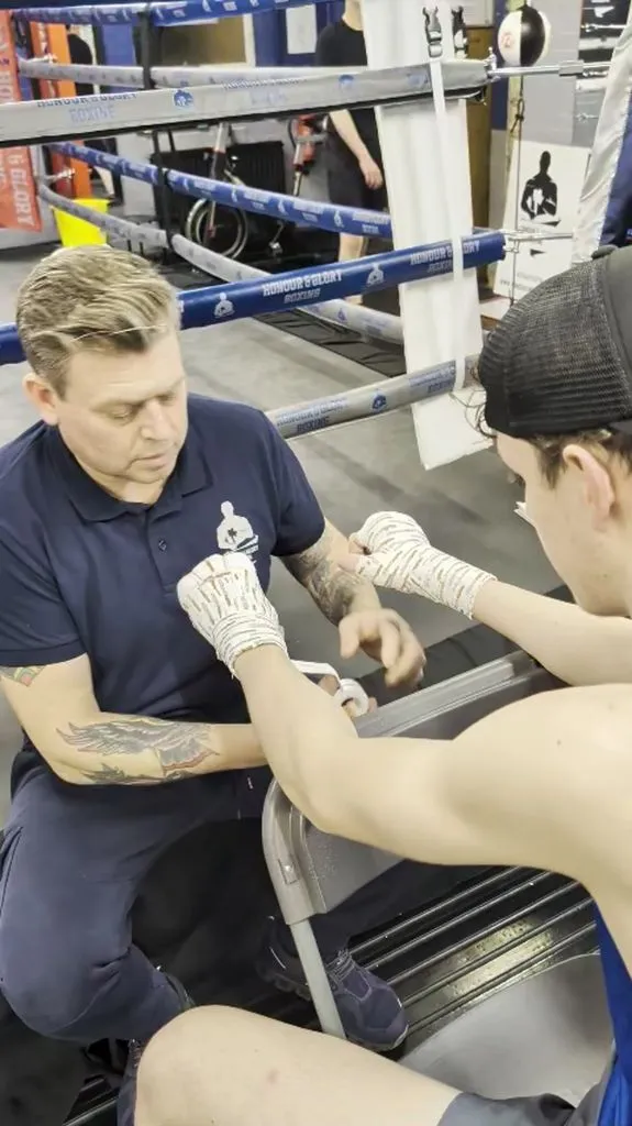 Anton wrapping a boxer's hands before a fight