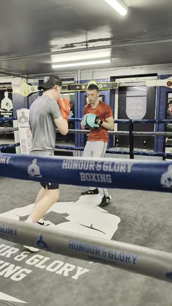 Coach Charles working pads in the ring at Honour and Glory