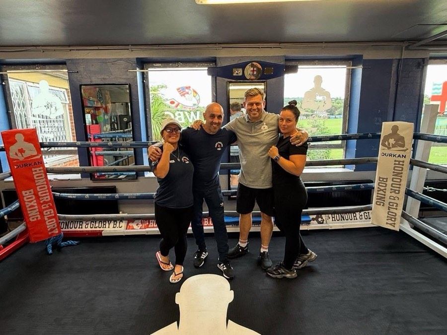 Visitors posing ringside at the club