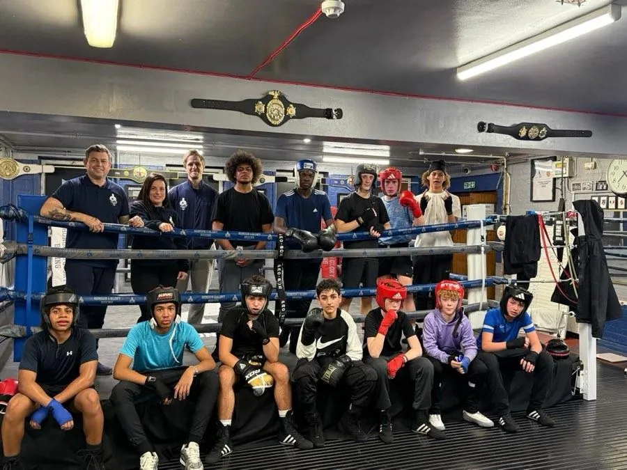 Honour and Glory boxers and coaches gathered inside the boxing gym
