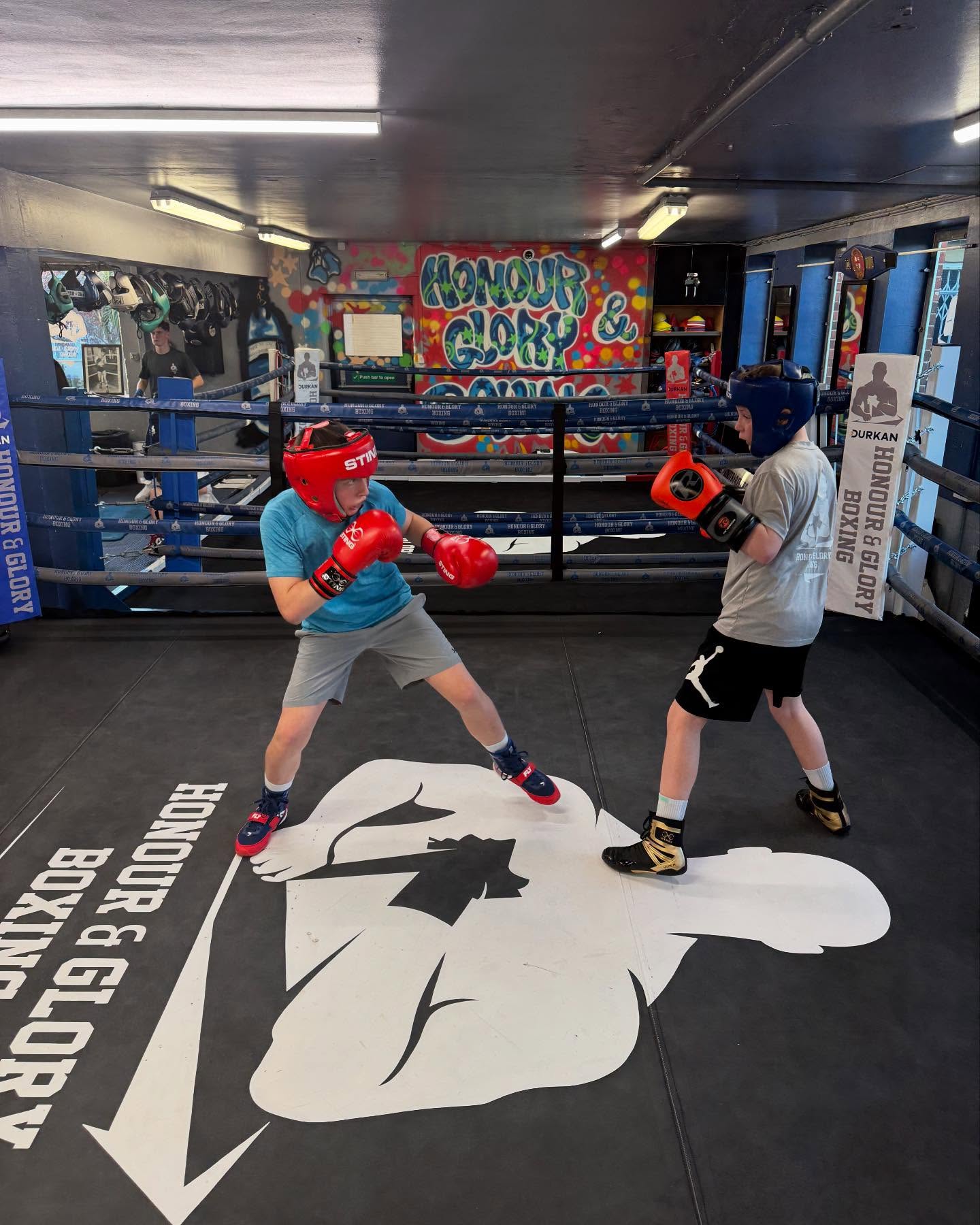 Youth boxers sparring with headgear