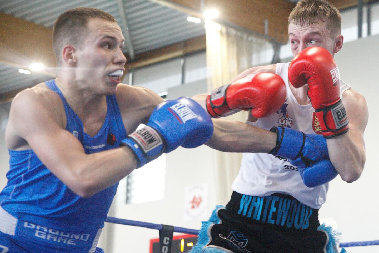 Amateur boxing match - fighters exchanging punches