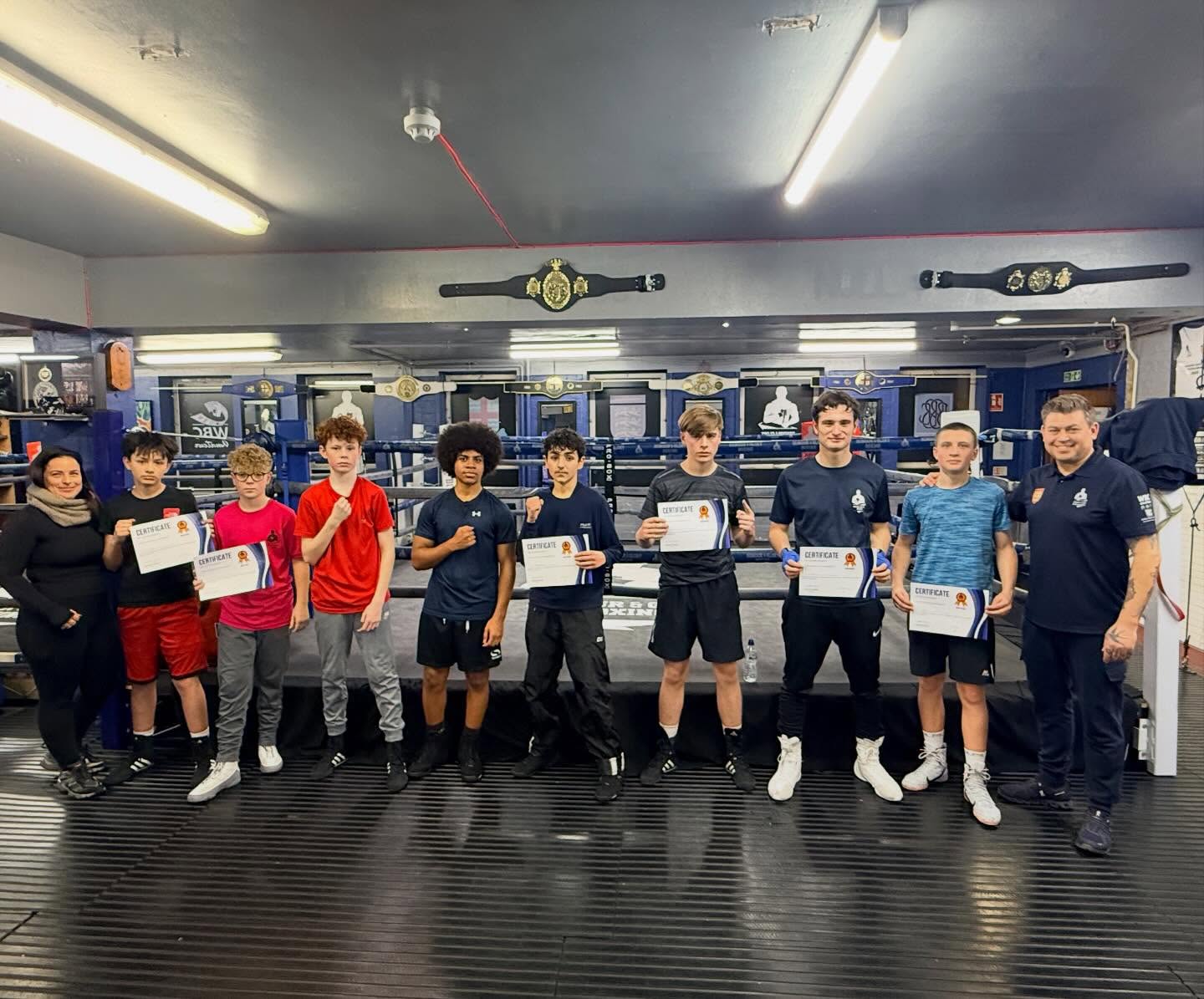 Youth boxers with certificates and coaches