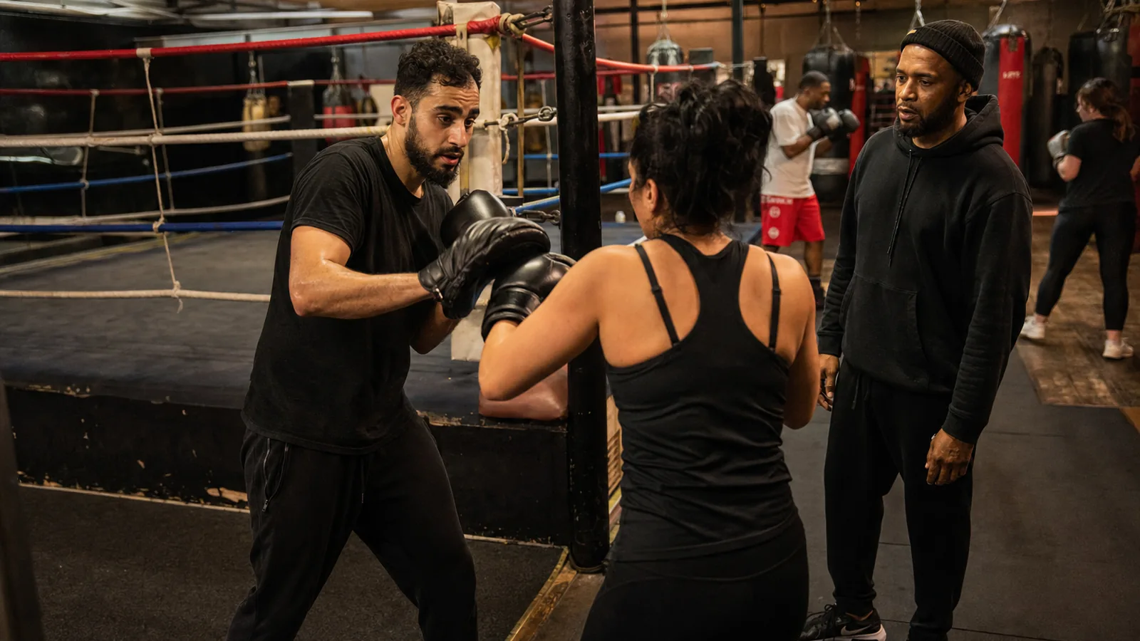 Adult recreational boxers training together in a boxing gym