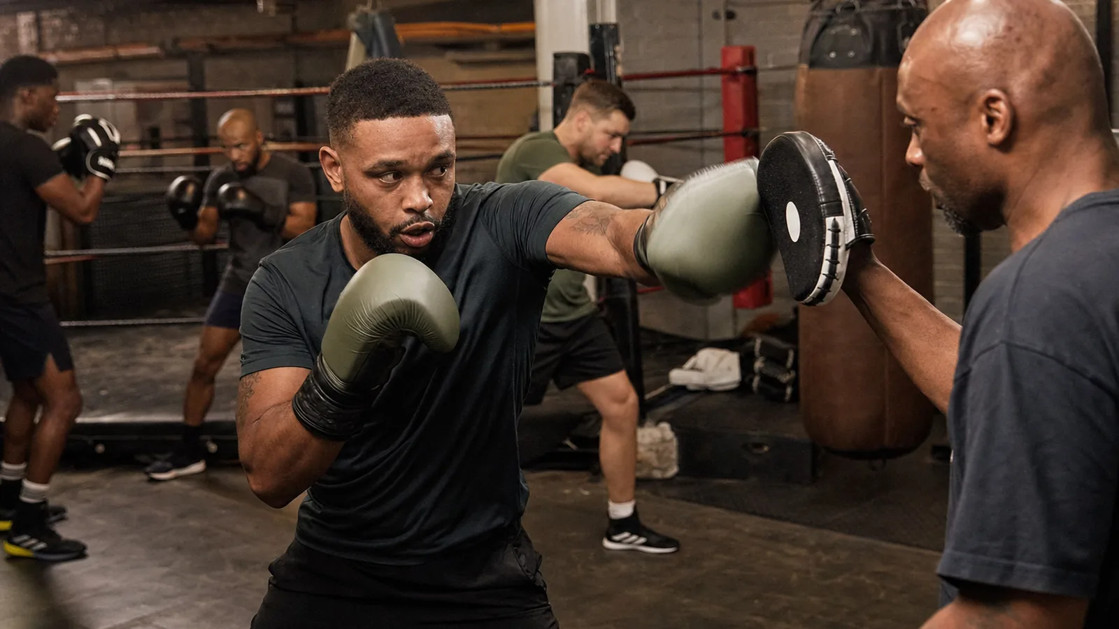 Boxing fitness class using pads and movement at Honour and Glory near Kidbrooke