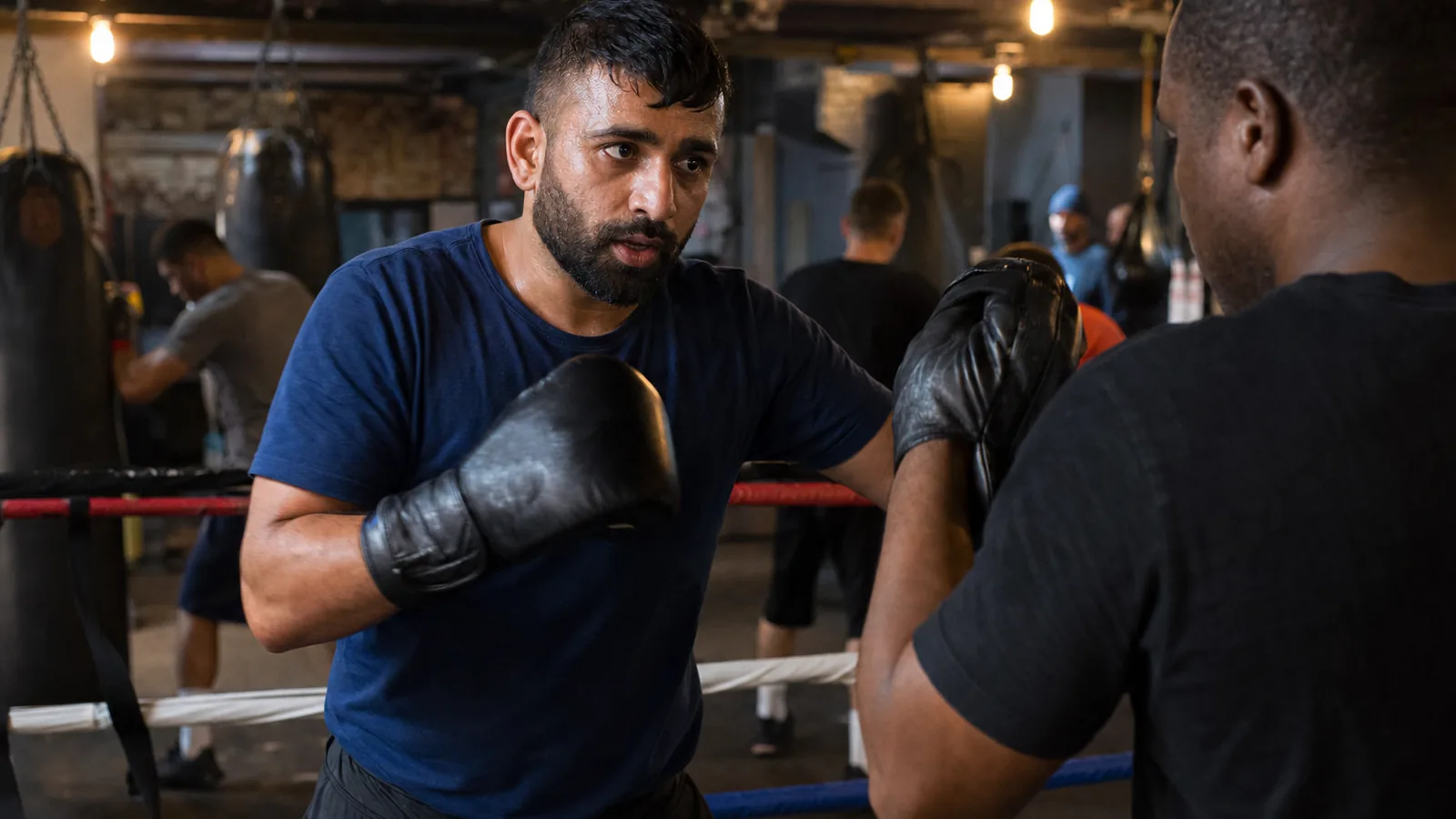 Women training boxing padwork at Honour and Glory
