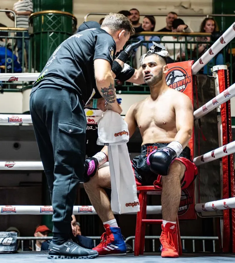 Professional boxer receiving licensed corner support between rounds